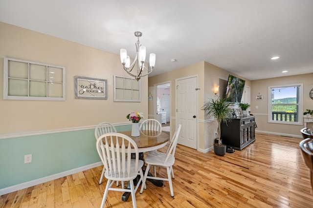 dining room with hardwood / wood-style floors, baseboards, a chandelier, and recessed lighting