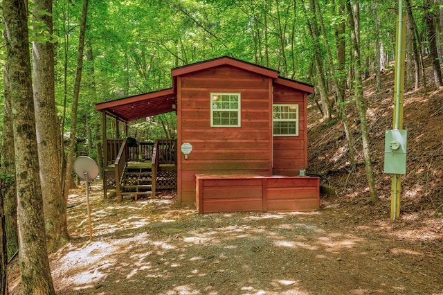 view of property exterior with an outbuilding