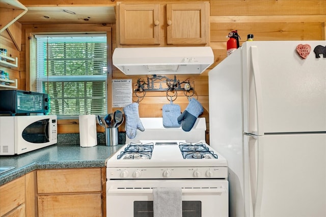 kitchen with white appliances and light brown cabinetry