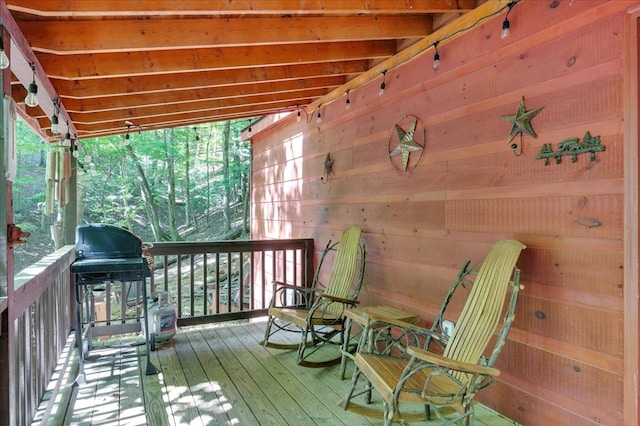 wooden deck with a grill