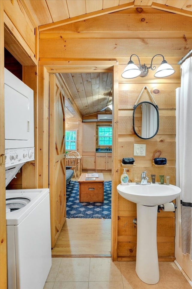 bathroom with wooden ceiling, wooden walls, lofted ceiling, hardwood / wood-style flooring, and stacked washer and clothes dryer