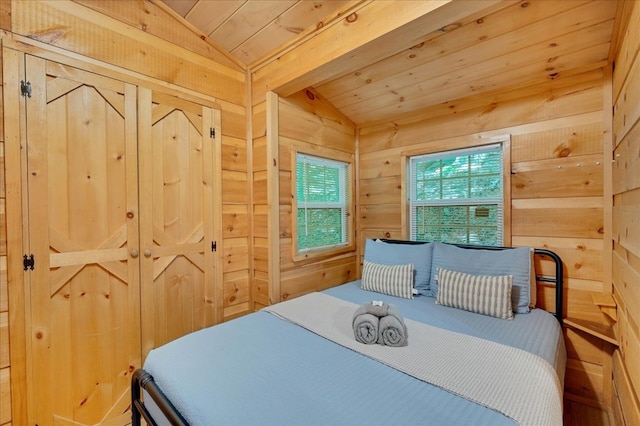 bedroom with wooden ceiling, wooden walls, and lofted ceiling