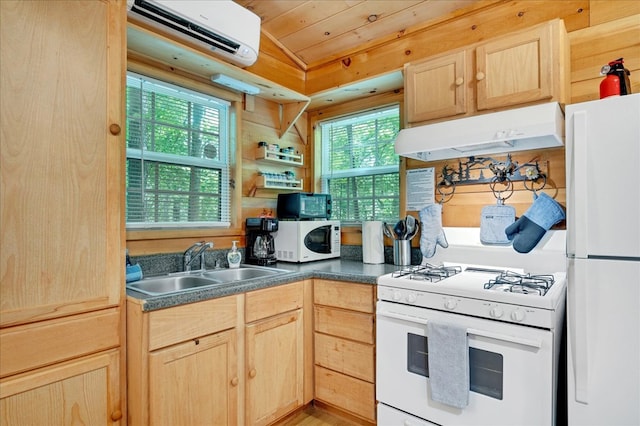 kitchen featuring a wall unit AC, light brown cabinets, white appliances, and plenty of natural light