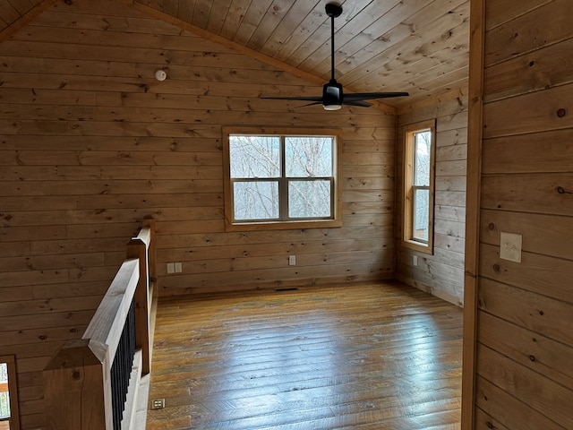 additional living space featuring lofted ceiling, light hardwood / wood-style flooring, wood ceiling, and wood walls