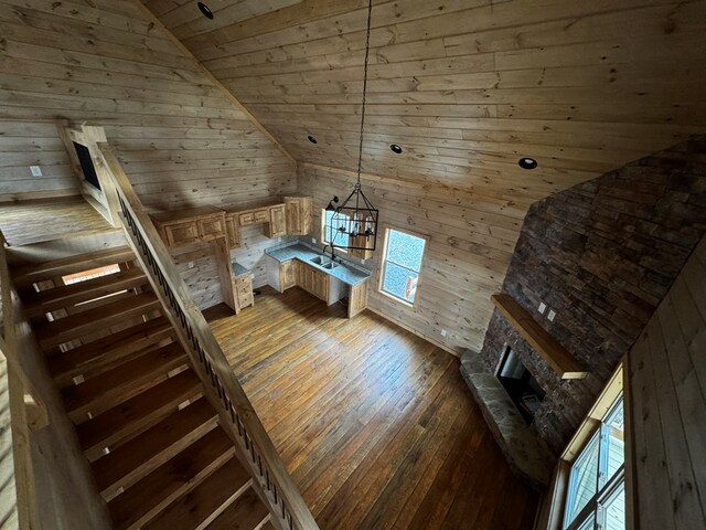 additional living space with vaulted ceiling, wood-type flooring, wood ceiling, and wood walls