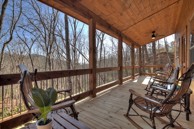 unfurnished sunroom featuring ceiling fan, vaulted ceiling, and wooden ceiling