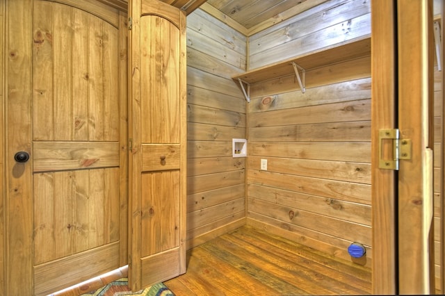 details featuring hardwood / wood-style floors and wood walls