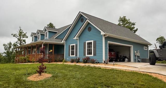 405 Lola Dr, Blairsville, GA 30512 - view of front of house featuring covered porch, a garage, concrete driveway, and a front lawn