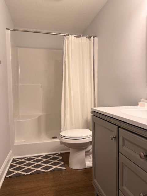 405 Lola Dr, Blairsville, GA 30512 - full bathroom with vanity, wood finished floors, toilet, a shower with curtain, and vaulted ceiling
