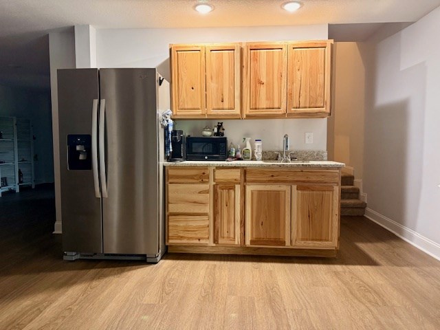 405 Lola Dr, Blairsville, GA 30512 - kitchen with stainless steel refrigerator with ice dispenser, light wood-style floors, a sink, black microwave, and baseboards