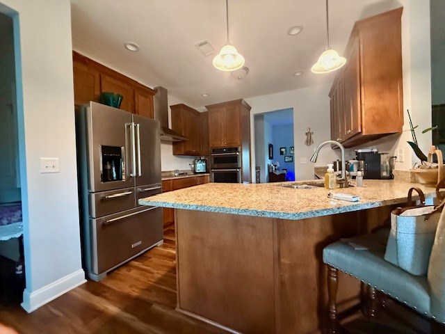 405 Lola Dr, Blairsville, GA 30512 - kitchen with appliances with stainless steel finishes, wall chimney exhaust hood, a sink, a peninsula, and dark wood-style flooring