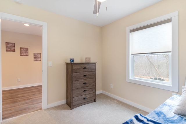 bedroom featuring baseboards, a ceiling fan, and light carpet