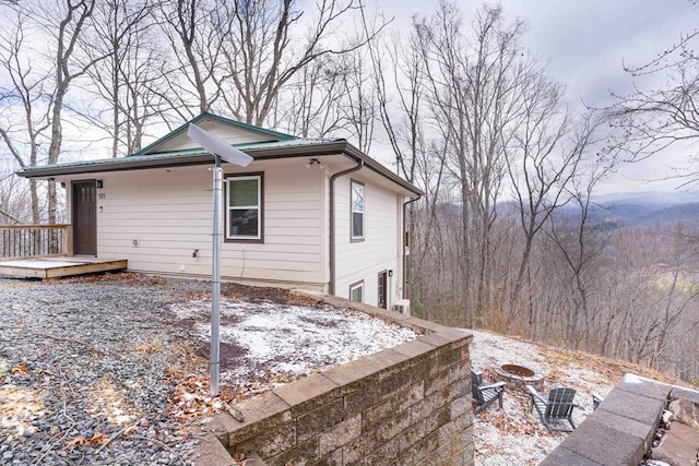 view of side of property featuring a wooden deck
