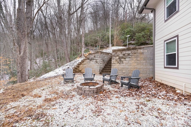 view of yard with an outdoor fire pit and stairway