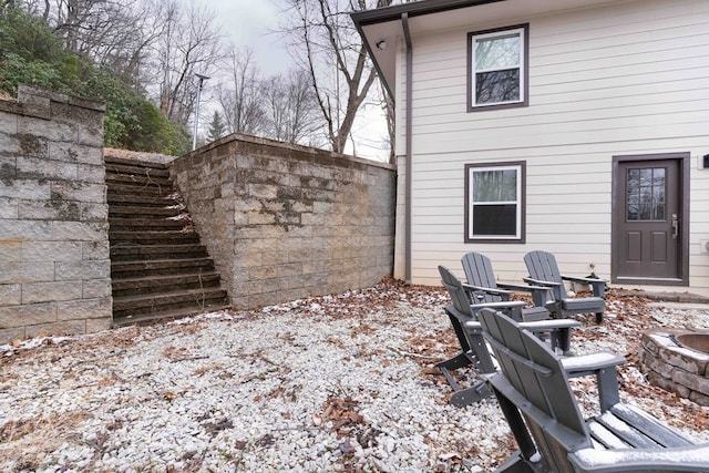 rear view of house with an outdoor fire pit