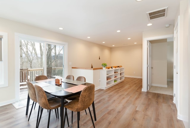 dining space with light wood-type flooring, baseboards, visible vents, and recessed lighting