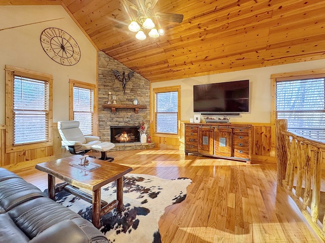 living room with a fireplace, wooden ceiling, wood finished floors, and wainscoting