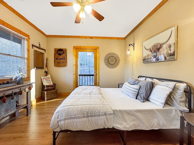 bedroom with wood finished floors, baseboards, ceiling fan, ornamental molding, and access to outside