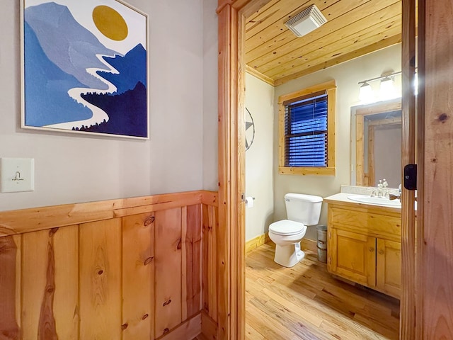 bathroom with visible vents, toilet, wood ceiling, wood finished floors, and vanity