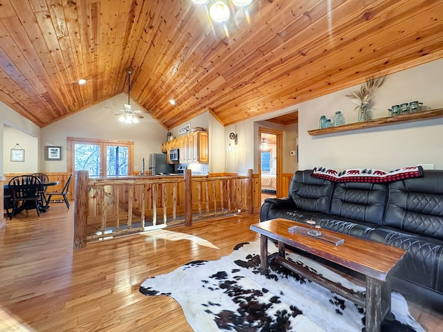 living room with a ceiling fan, wainscoting, light wood finished floors, lofted ceiling, and wood ceiling