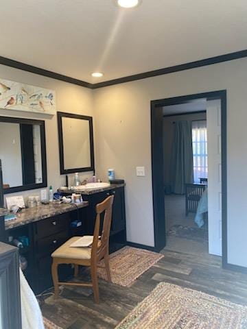 bathroom with vanity, ornamental molding, and hardwood / wood-style flooring