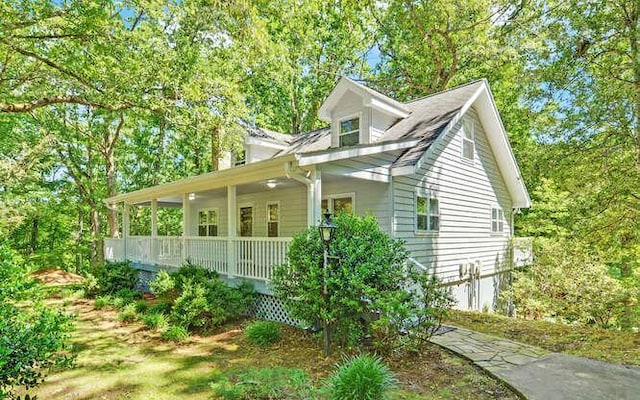 view of side of property featuring covered porch