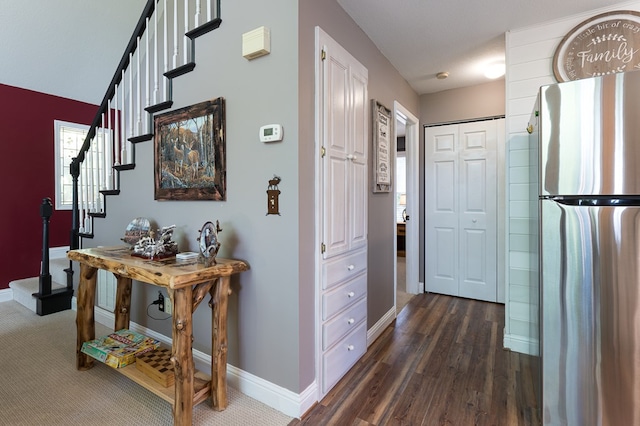 hallway featuring dark hardwood / wood-style flooring and a textured ceiling