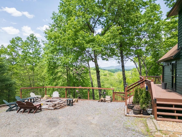 view of patio / terrace with a fire pit and a wooden deck