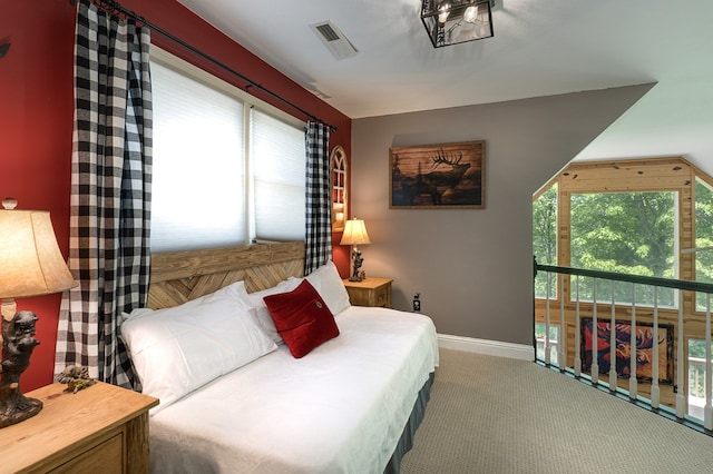 bedroom featuring multiple windows and carpet