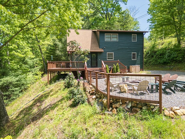 rear view of house featuring a wooden deck