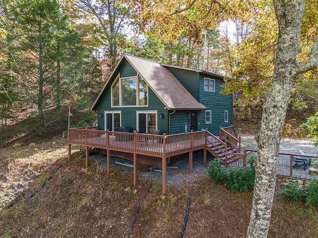 back of property featuring a wooden deck