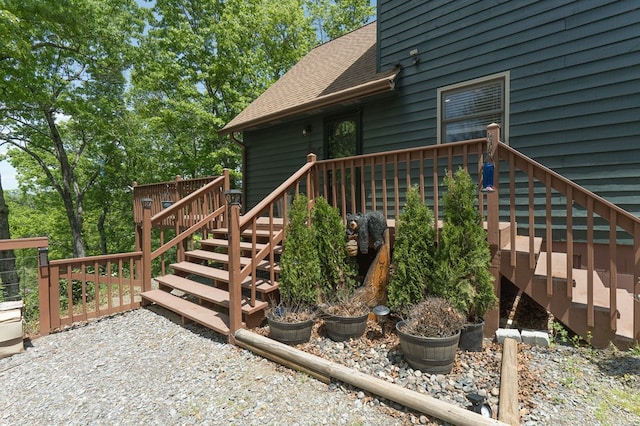 view of exterior entry featuring a wooden deck