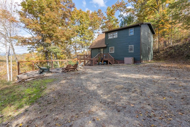 rear view of property featuring a deck