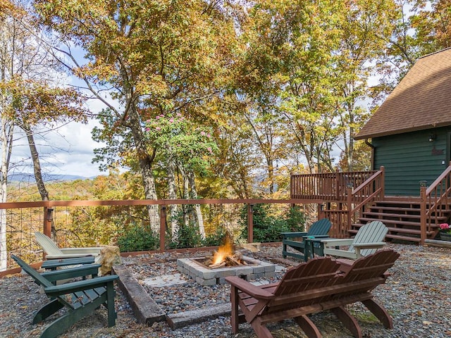 view of patio / terrace with a deck and an outdoor fire pit