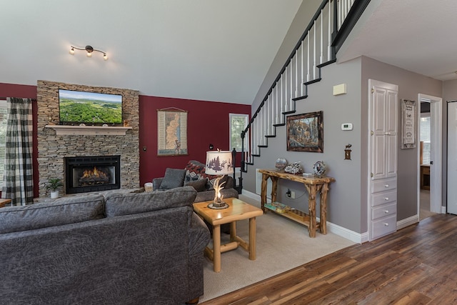 living room featuring vaulted ceiling, hardwood / wood-style flooring, and a fireplace