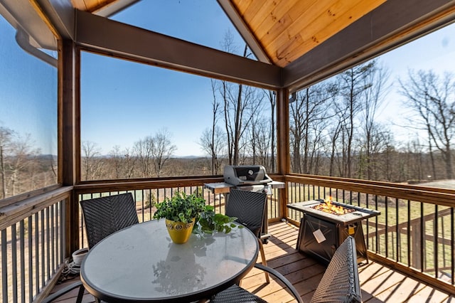 wooden deck with area for grilling and outdoor dining area