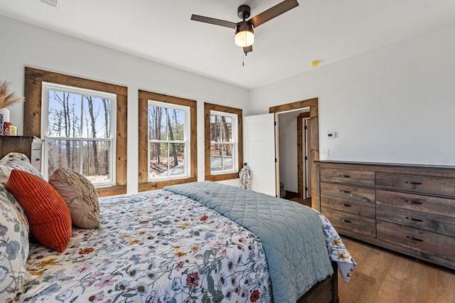 bedroom with a ceiling fan and wood finished floors