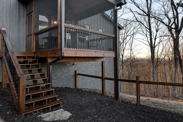 view of side of property featuring stairs