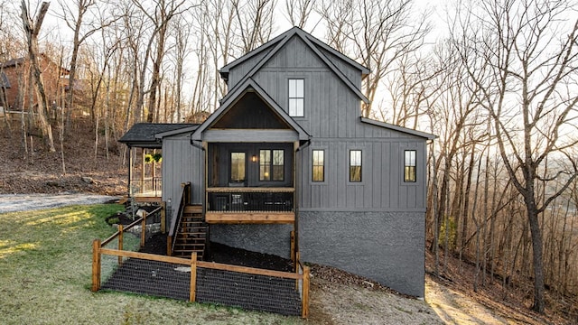 view of front of house featuring stairs and a front lawn