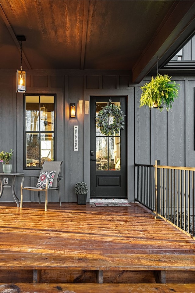 property entrance with board and batten siding and a porch