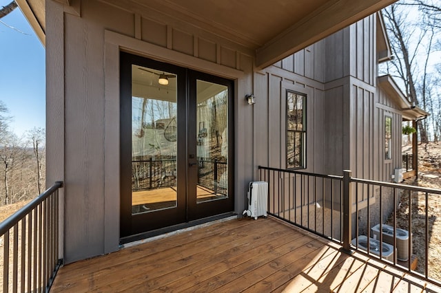 entrance to property featuring french doors, radiator, and board and batten siding