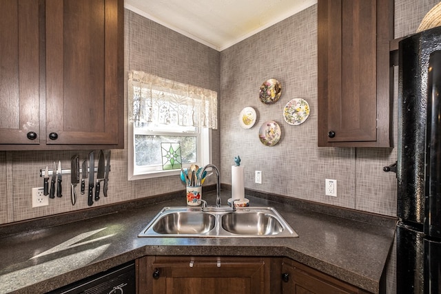 kitchen with crown molding, dark brown cabinets, sink, and black appliances