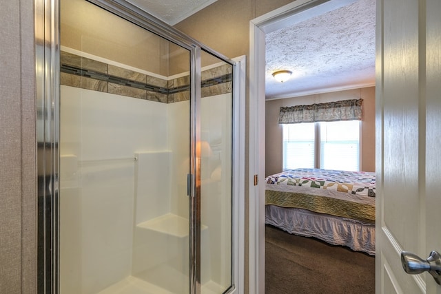 bathroom featuring a shower with door and a textured ceiling