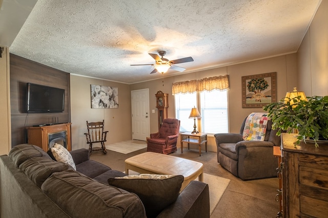 living room with ceiling fan, ornamental molding, light carpet, and a textured ceiling