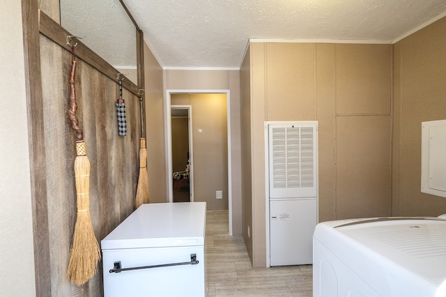 laundry room with washer / dryer and a textured ceiling