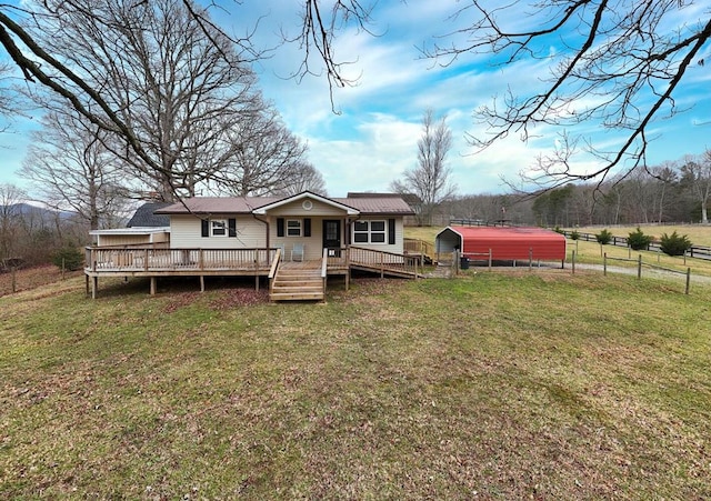 back of house with a wooden deck and a lawn