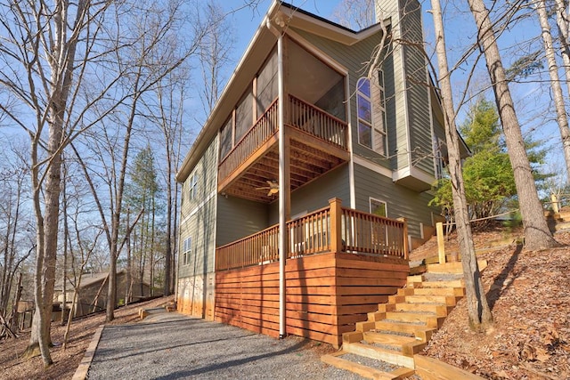 149 Pinecrest Ct, Ellijay, GA 30540 - view of home's exterior featuring a wooden deck, a chimney, stairway, and a sunroom