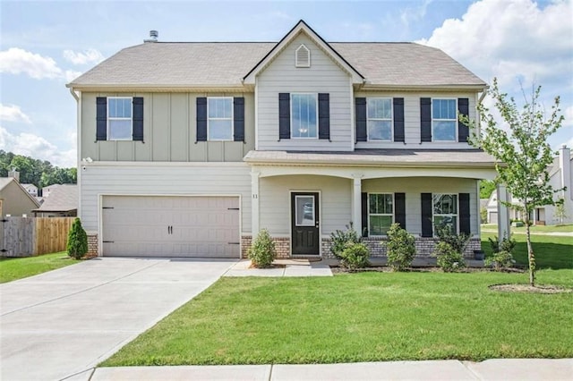 view of front of property with fence, a front lawn, concrete driveway, a garage, and board and batten siding