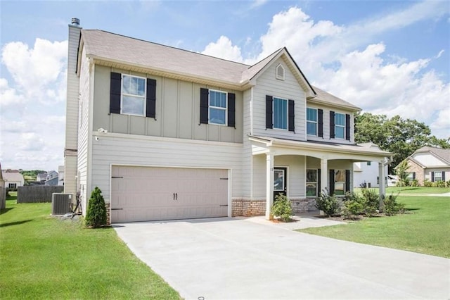 craftsman-style home featuring board and batten siding, a front lawn, concrete driveway, central AC, and an attached garage