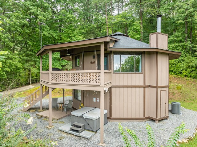 view of patio featuring a deck and a hot tub